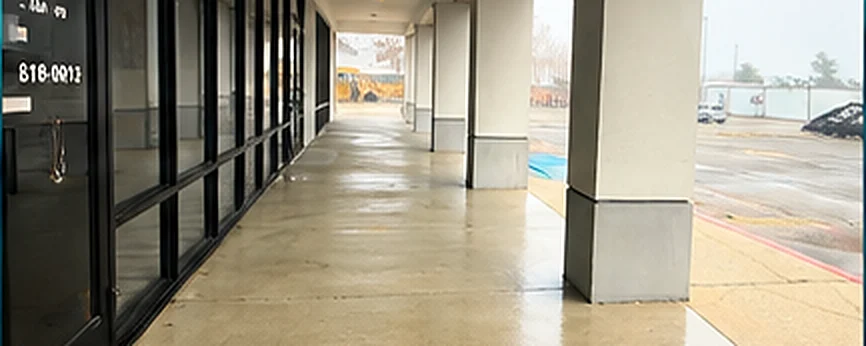 Covered storefront walkway after pressure washing by Divine