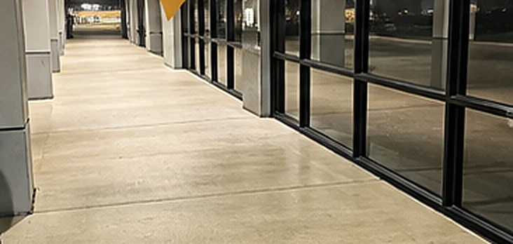 Shopping center walkway after pressure washing by Divine