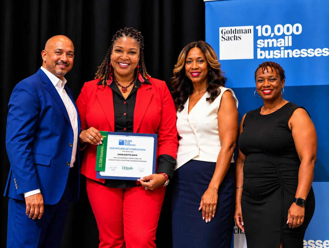 Charlesetta Davis, Founder and President of Divine Cleaning and Janitorial, holding her Goldman Sachs 10,000 Small Businesses certificate with program staff