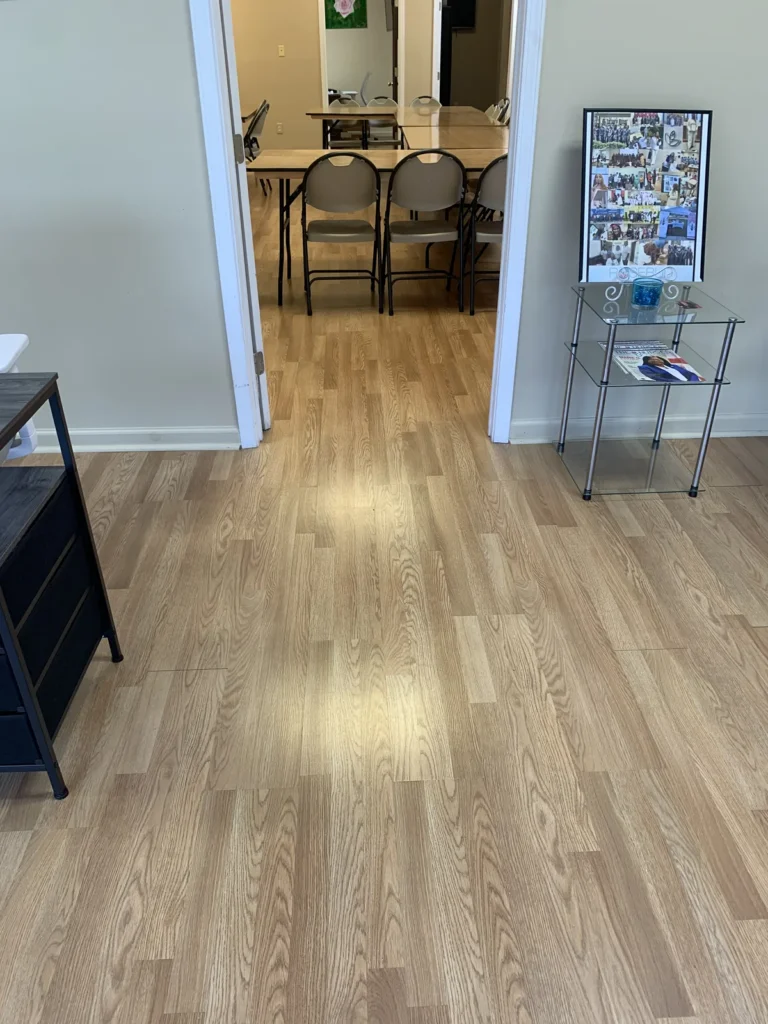 Clean wood-look floor in an office lobby after service by Divine Cleaning and Janitorial